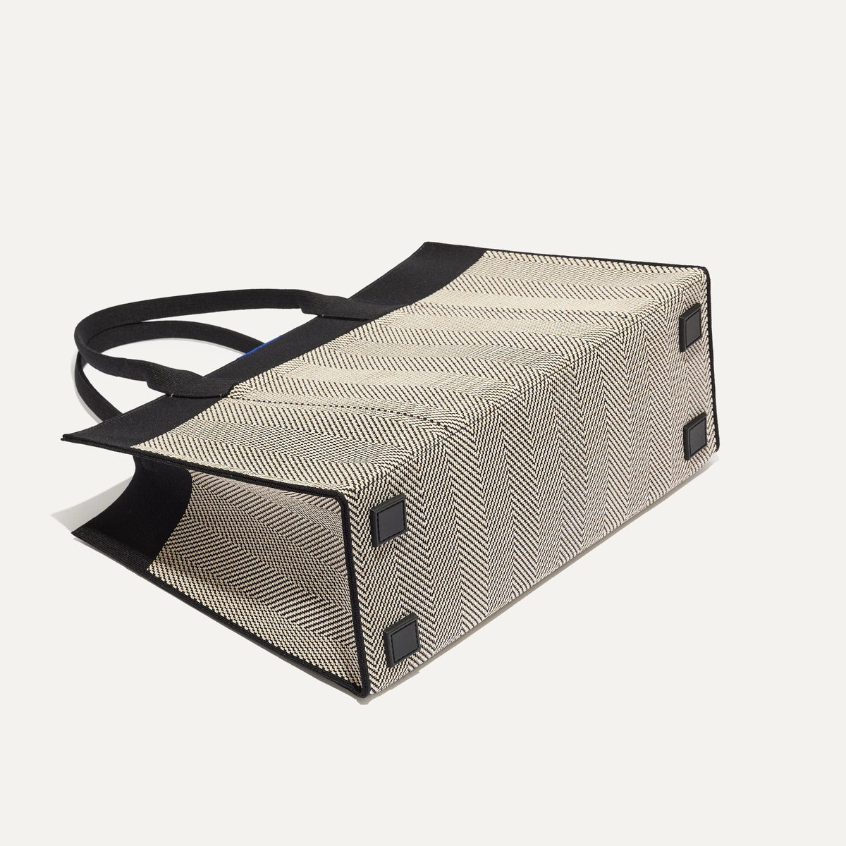 The Classic Tote in Black Herringbone, shown from the bottom.