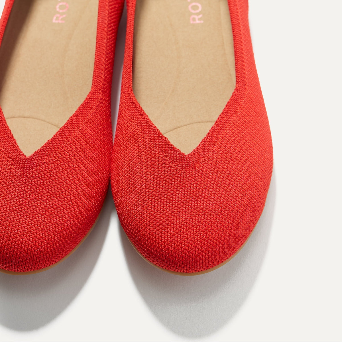 Close up of the toe and vamp of The Daily Flat in Showstopper Red.