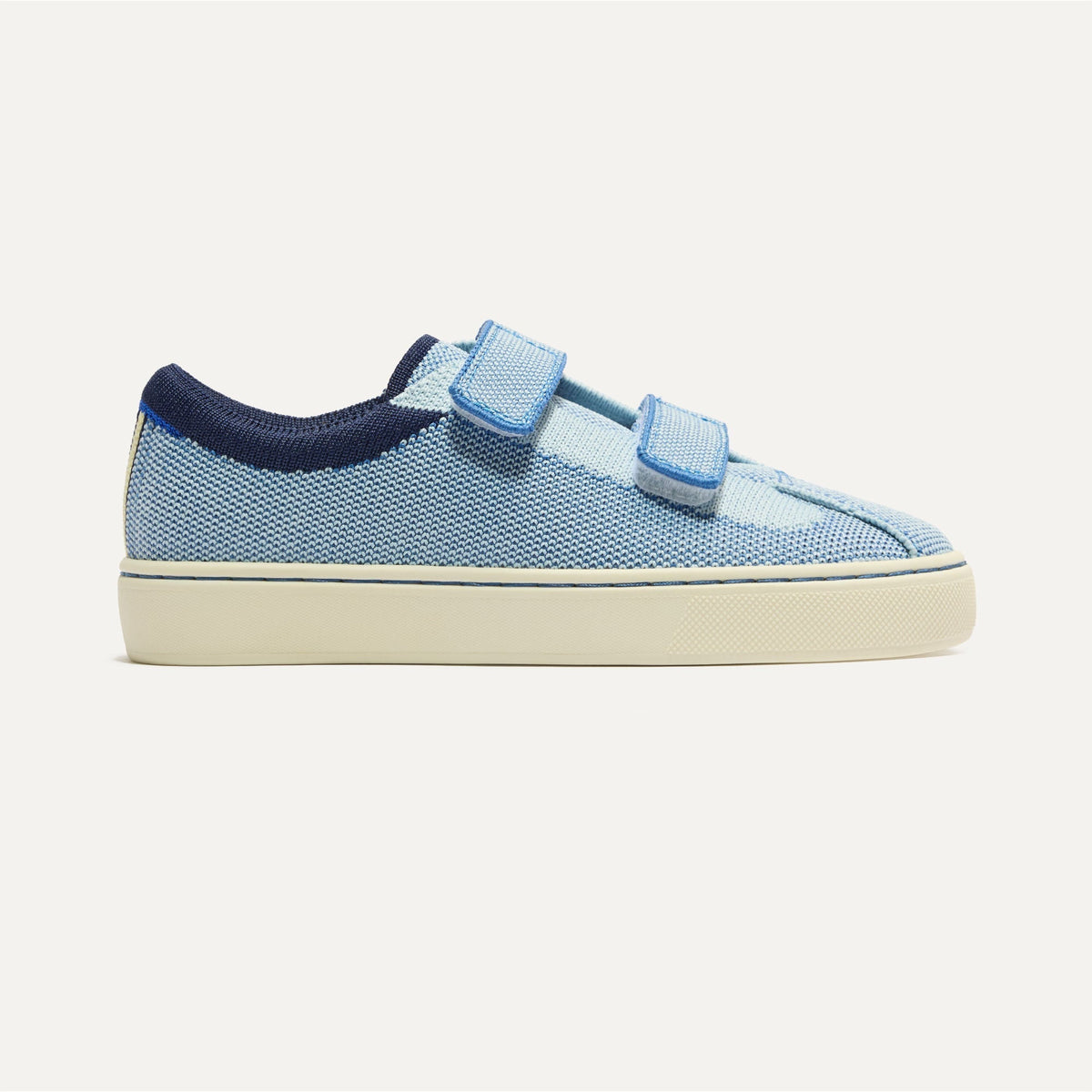 side | The Kids Strap Sneaker in Berry Blue shown from the side.