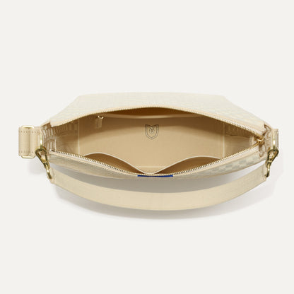 The Mini Zip Bucket in White Sand shown from the top down, with zipper open and interior exposed.