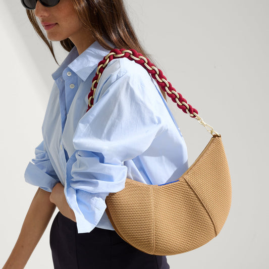 hover | The Shoulder Strap in Cranberry Chain, shown paired with The Crescent Bag, worn by a model and shown from the side.