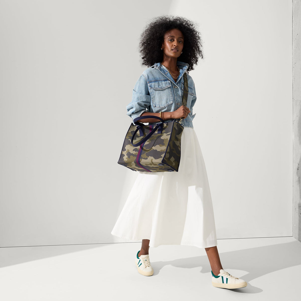 model | Overlay:: Shown with The Crossbody Strap (sold separately). | Alt:: Alternate view of a model wearing The RS02 Sneaker in Kelly.