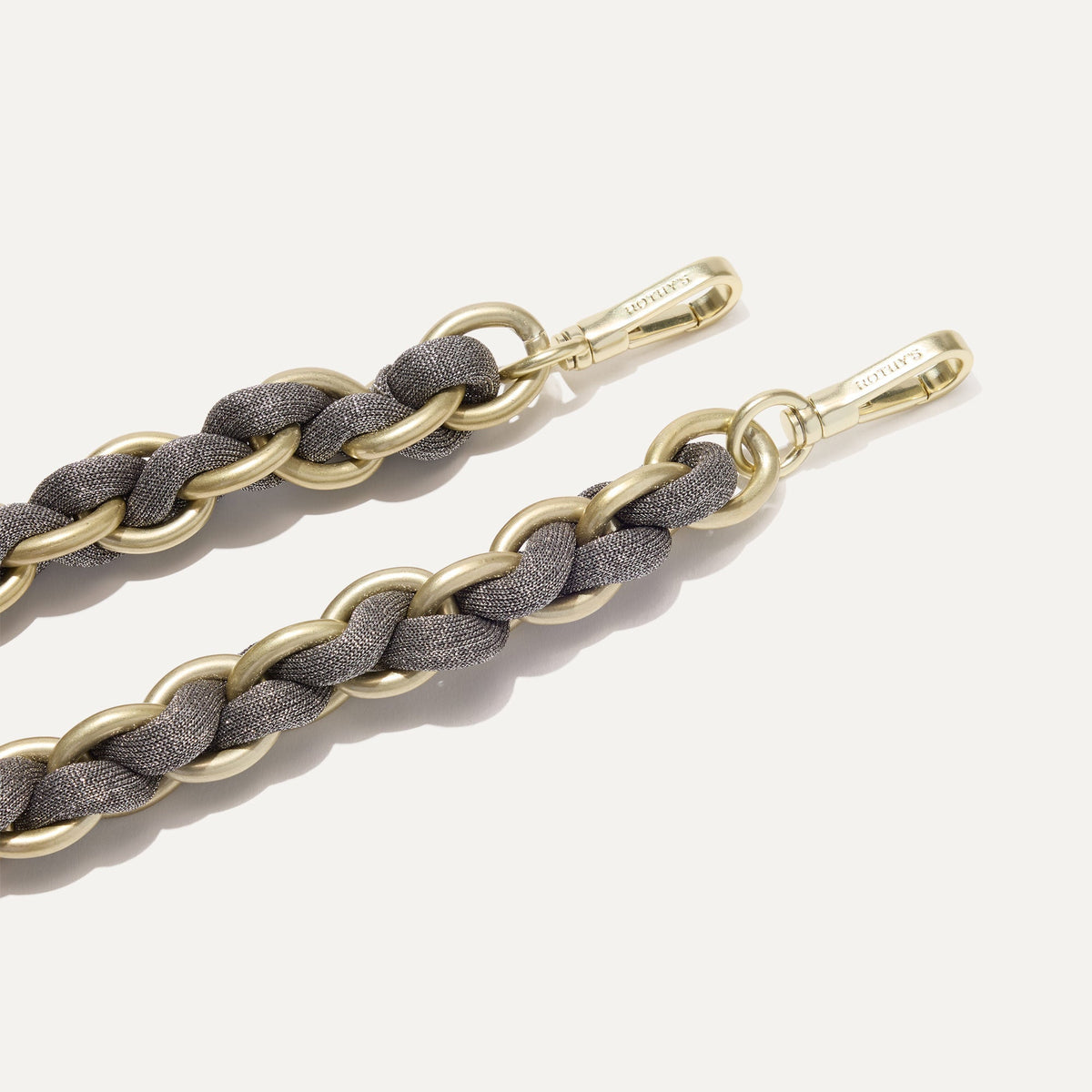 A close-up of The Shoulder Strap in Golden Silver Chain, focusing on the end snap hooks.