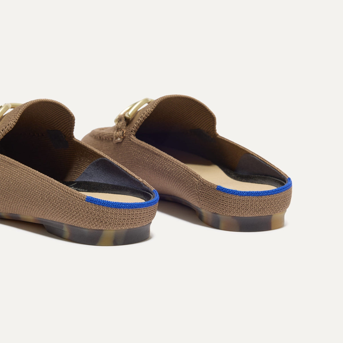 Close up of the heel of The Double Bit Loafer Mule in Portobello, with Rothy's signature blue halo.