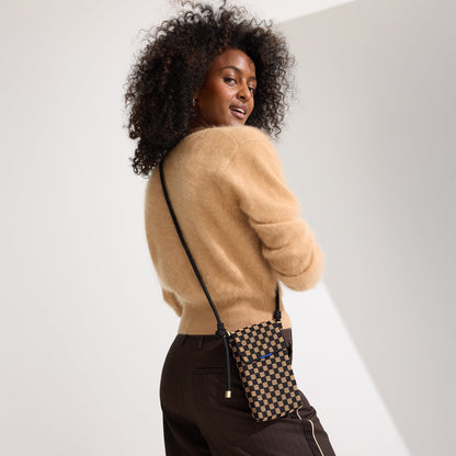 hover | A model wearing The Phone Crossbody in Midnight Song.