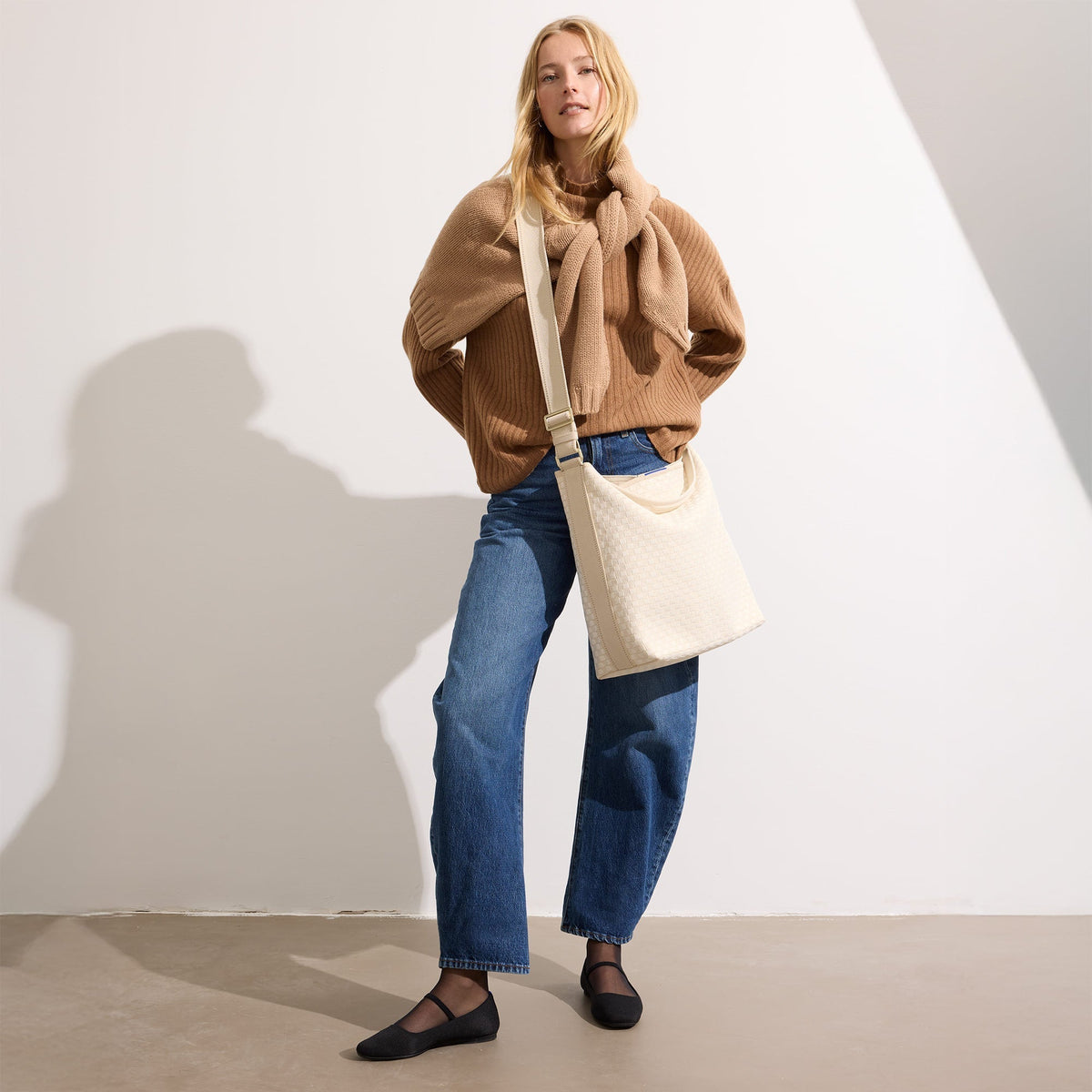 hover | The Bucket Bag in White Sand shown worn differently on model.