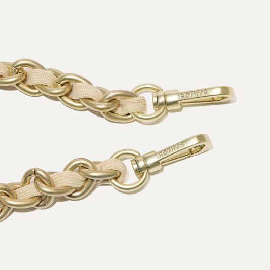 A close-up of The Crossbody Strap in Powder Chain, focusing on the end snap hooks.