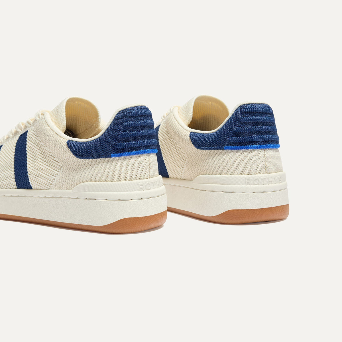 Close up of the heel of The Men's Court Sneaker in Freestyle, with Rothy's signature blue halo.