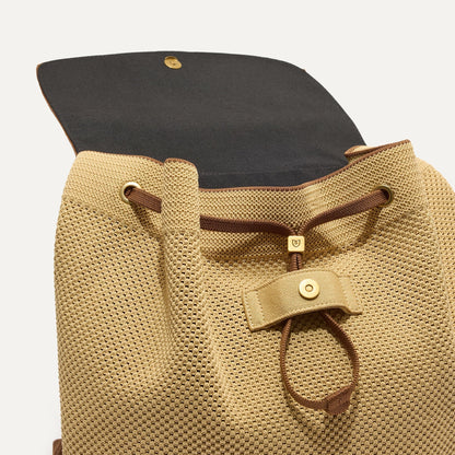 A close up of The Cinch Backpack in Brown Butter showing the drawstring closure.