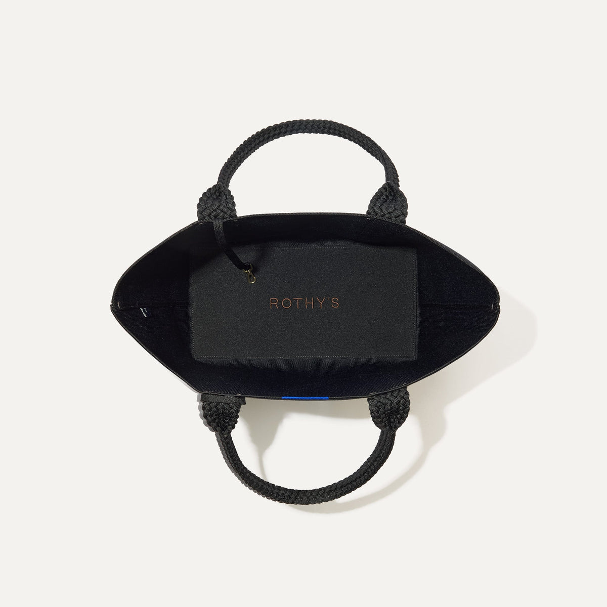 The Lightweight Tote in Black Licorice shown open from the top, with base insert visible.