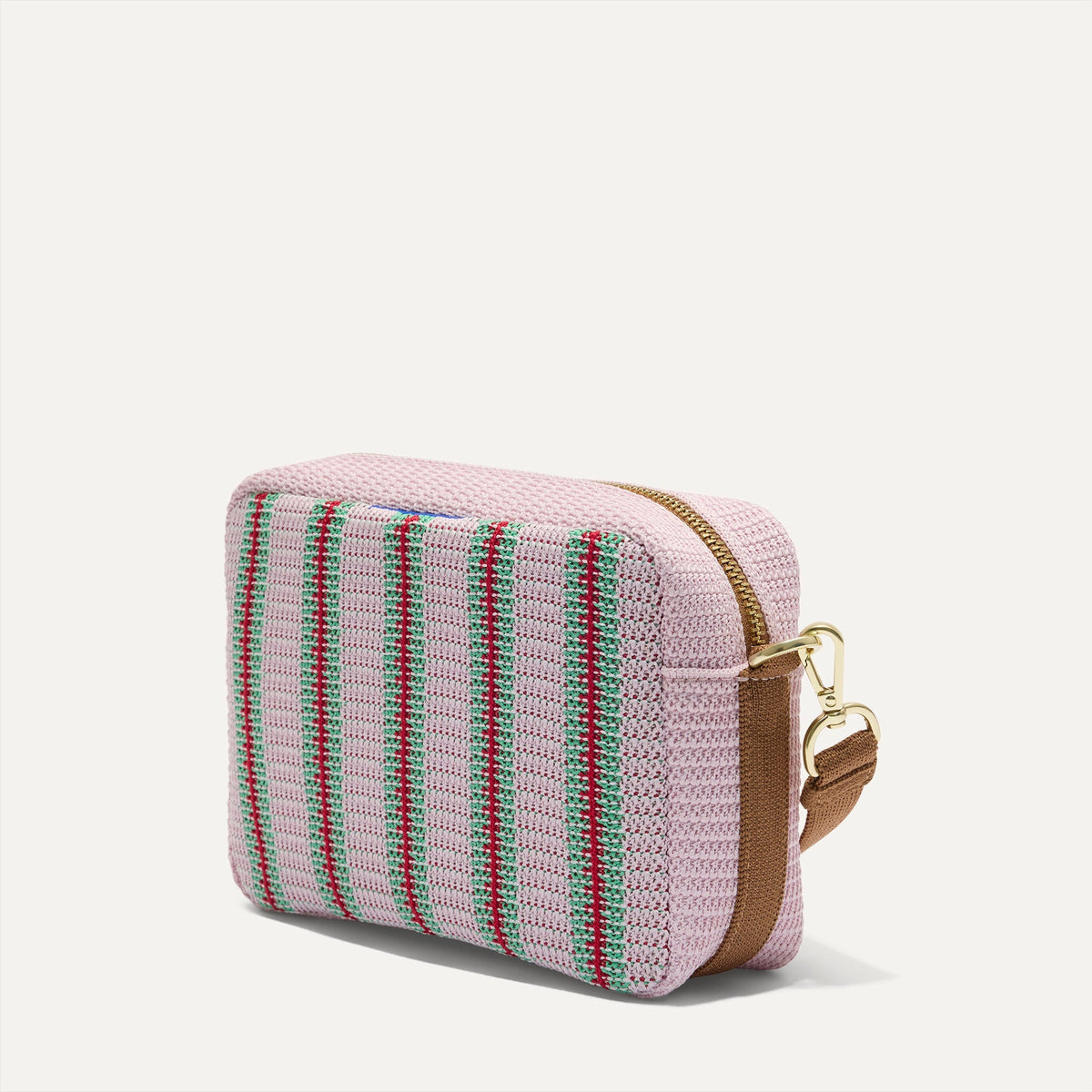 The Crossbody Camera Bag in Watermelon Market Stripe, shown from the side.