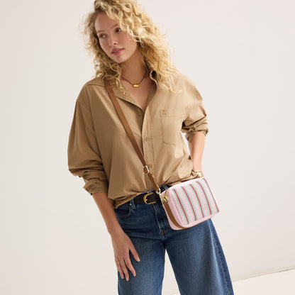 hover | The Crossbody Camera Bag in Watermelon Market Stripe worn as a crossbody by a model.