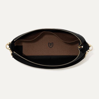 The Daily Crossbody in Revelvet™ Black shown from the top down, with zipper open and interior exposed.