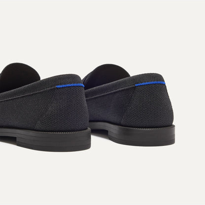 Close up of the heel of The Penny Loafer in Black, with Rothy's signature blue halo.