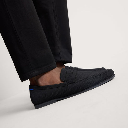 hover | Model wearing The Ravello Penny Loafer in Black.