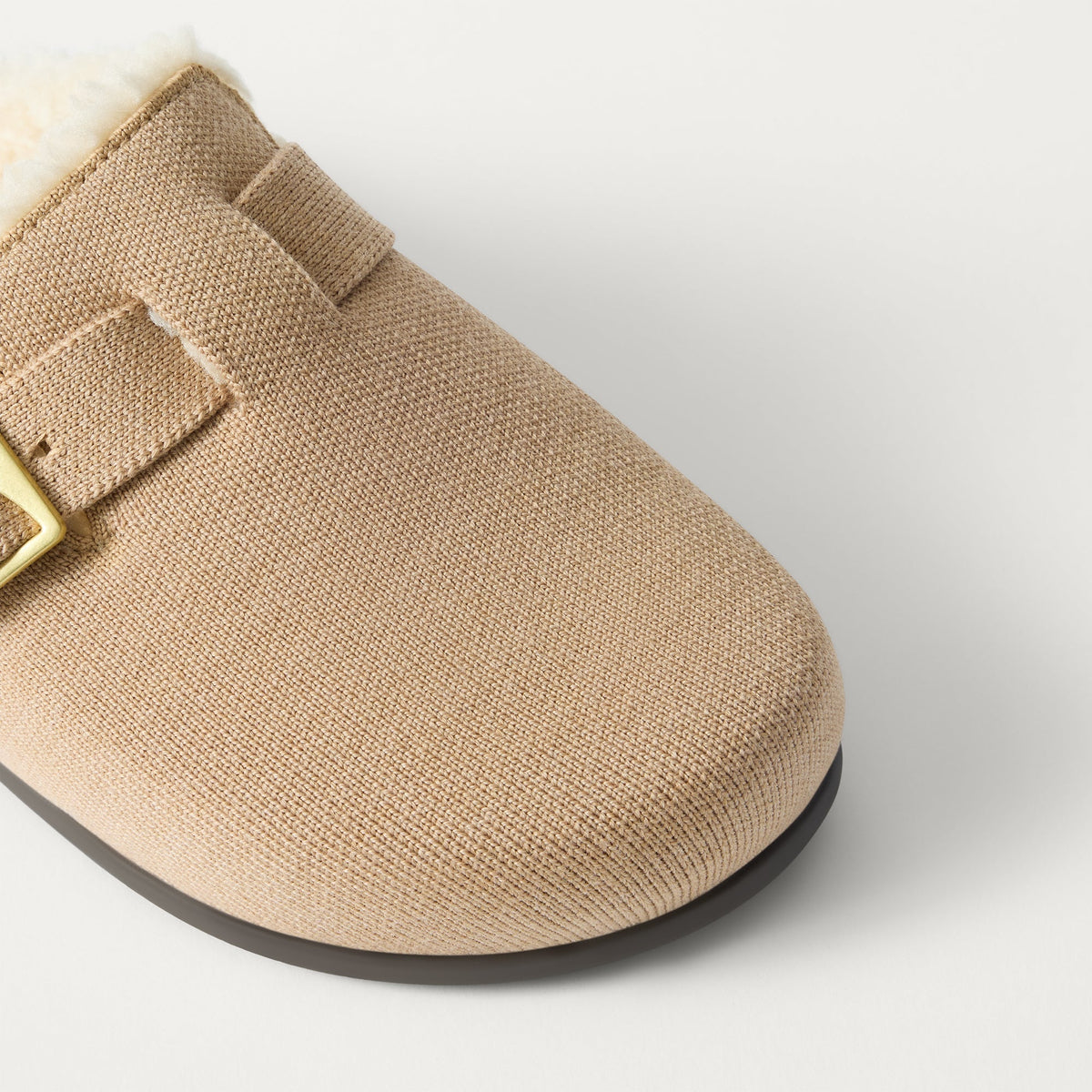 Close up of the buckle detail and vamp of The Teddy Buckle Clog in Honey.