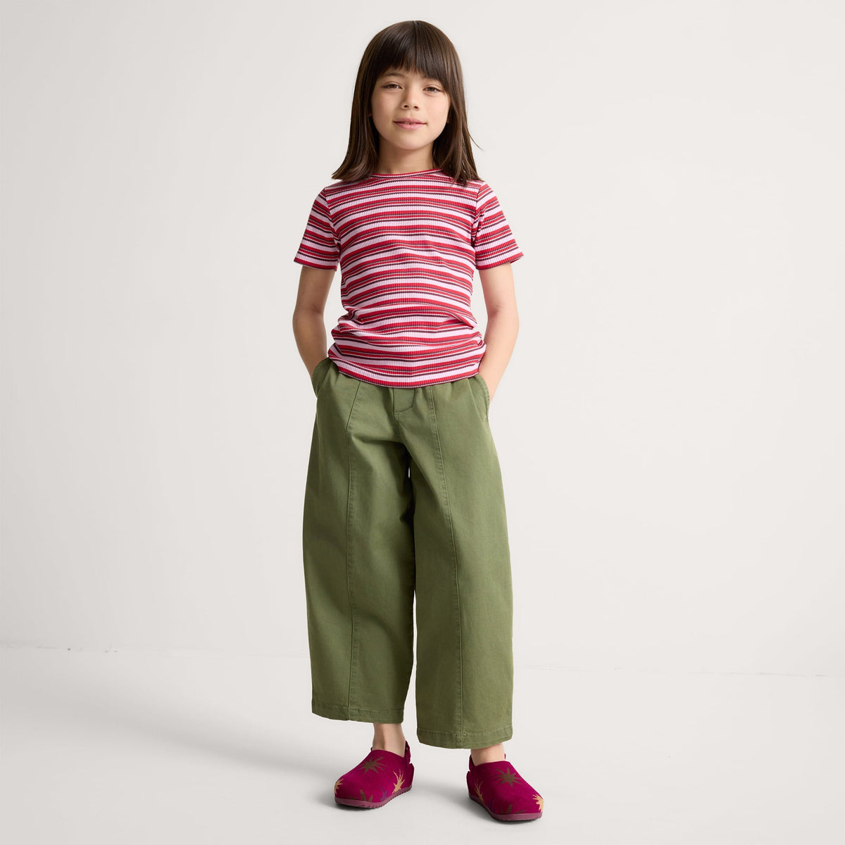 Alternate view of a model wearing The Kids Clog in ReVelvet™ Fuchsia Burst.