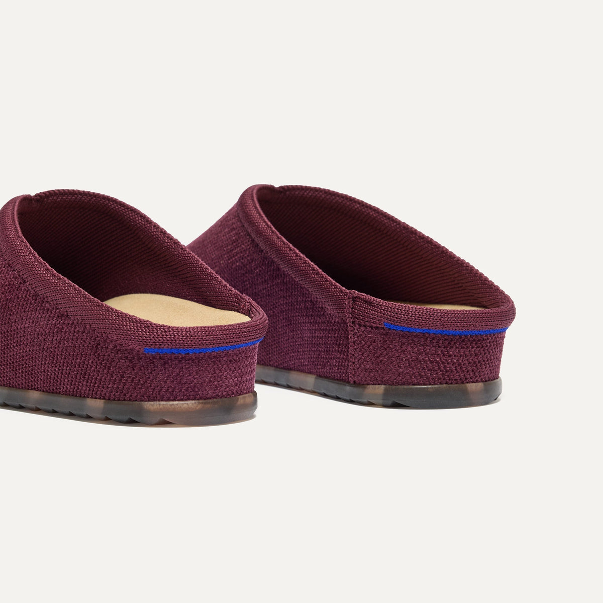 Close up of the heel of The Casual Clog in ReVelvet™ Syrah, with Rothy's signature blue halo.