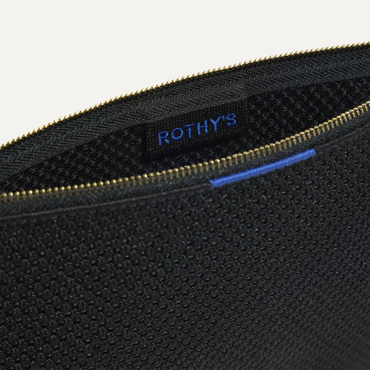 The Convertible Clutch in Black Espresso Open-Knit, shown open from the top in diagonal view.