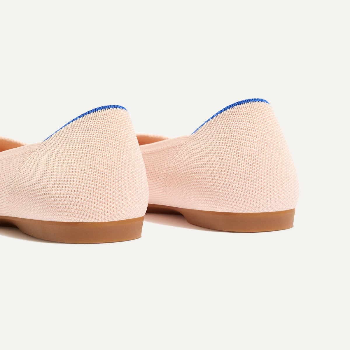Close up of the heel of The Daily Flat in Bubbly Pink, with Rothy's signature blue halo.