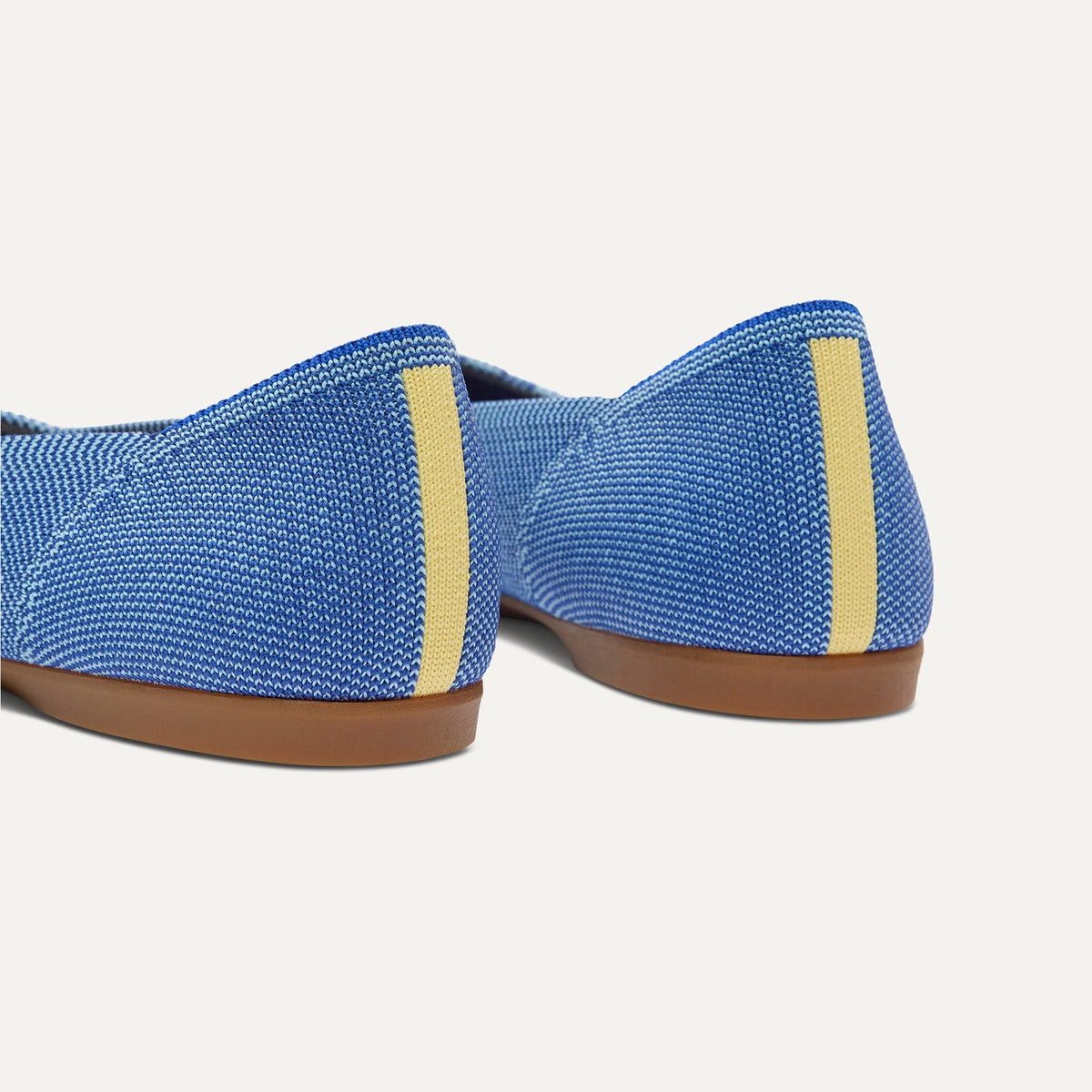 Close up of the heel of The Daily Flat in Clear Blue, with Rothy's signature blue halo.