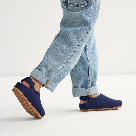 hover | A child wearing The Kids Clog in Deep Navy.
