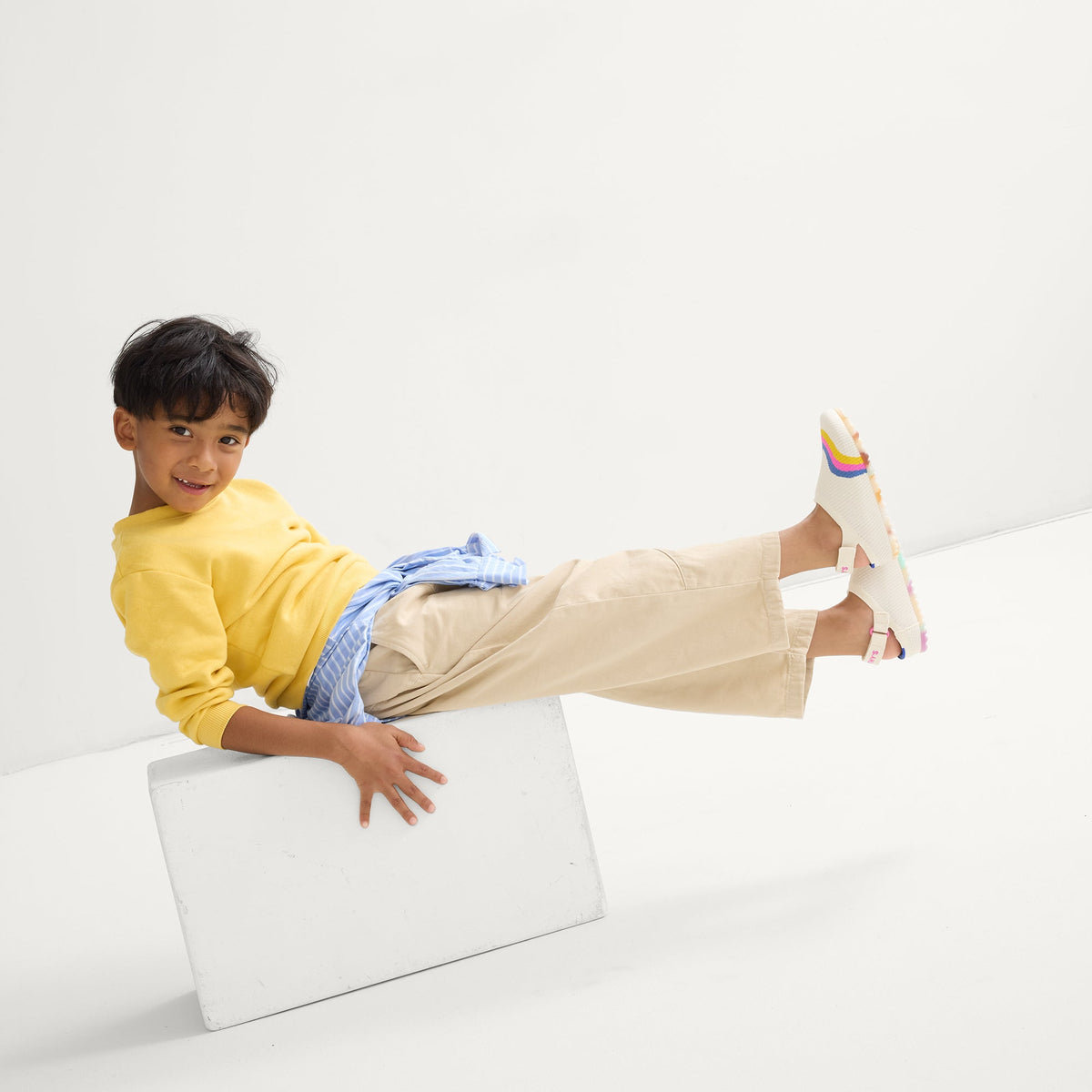 model | Alternate view of a child wearing The Kids Clog in Retro Wave.