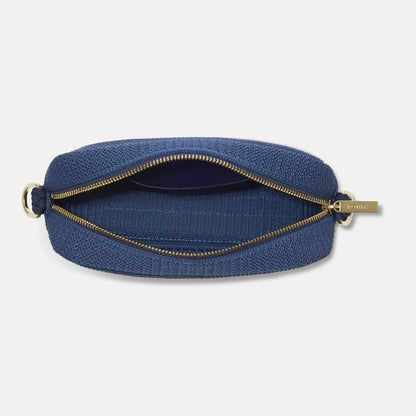 The Crossbody Camera Bag in Lagoon Open-Knit, shown from above, with the interior exposed.