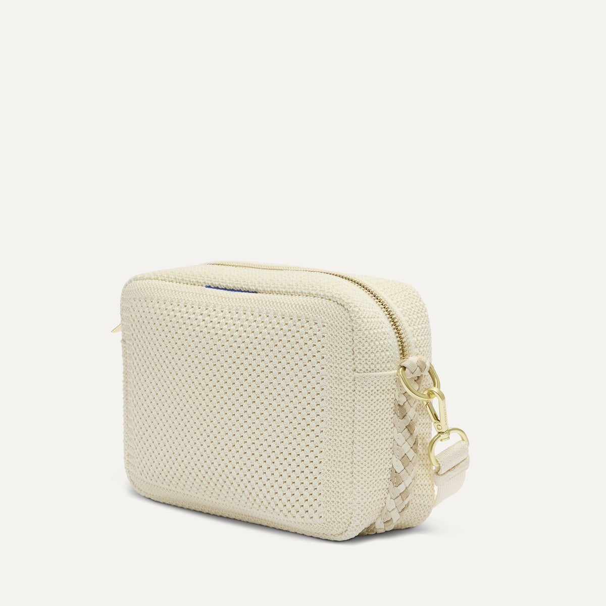 The Crossbody Camera Bag in Cream Twist Open-Knit, shown from the side.