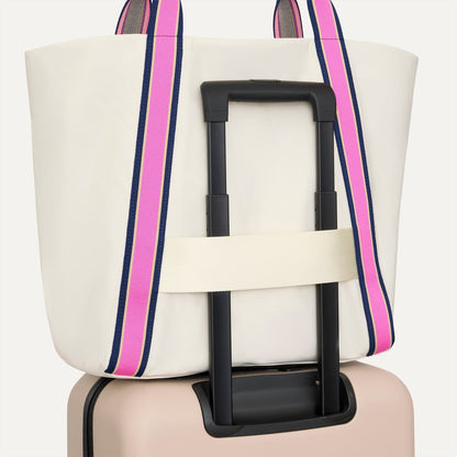 The Travel Tote in Optic, shown attached to a rolling suitcase using the wrap-around band.