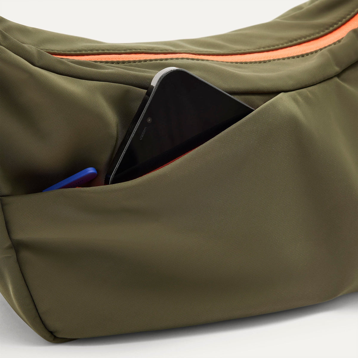 The Travel Sling in Forest shown closed from the top showcasing the side pocket.
