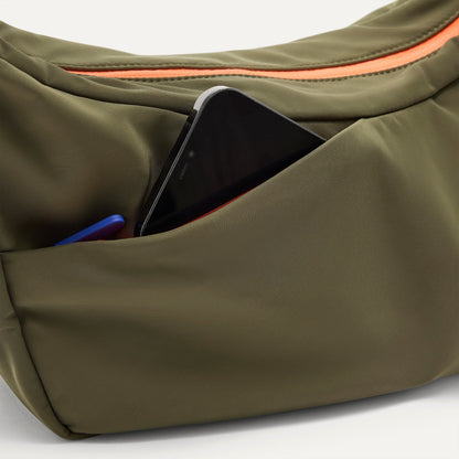 The Travel Sling in Forest shown closed from the top showcasing the side pocket.