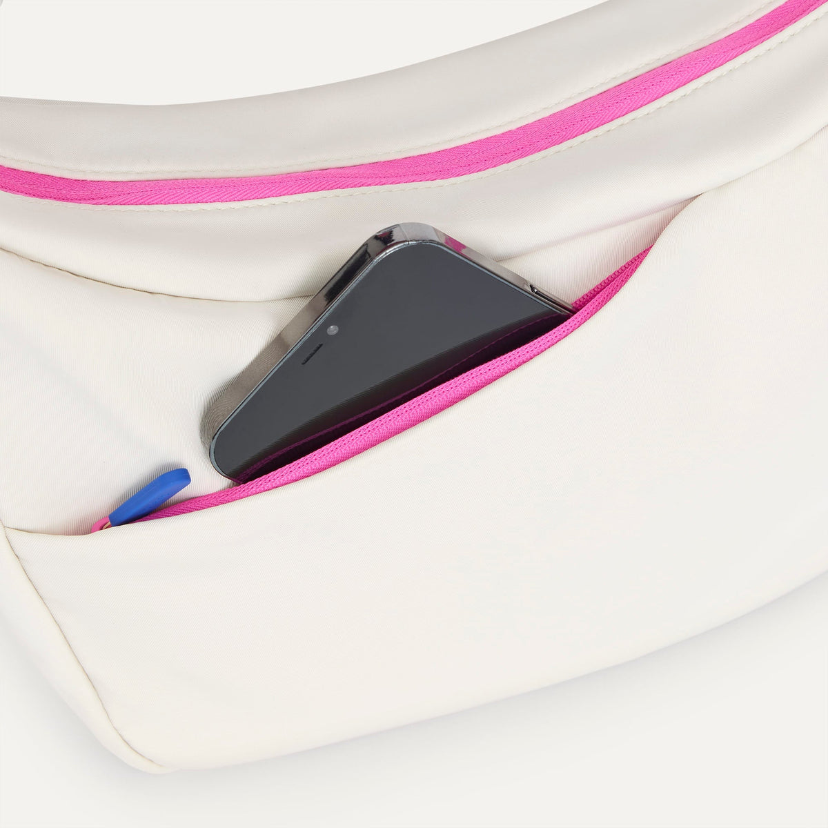 The Travel Sling in Optic shown closed from the top showcasing the side pocket.