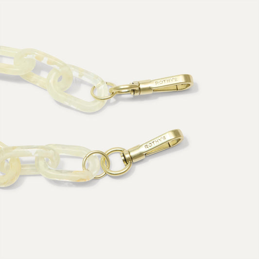 A close-up of The Shoulder Strap in Opal White Chain, focusing on the end snap hooks.