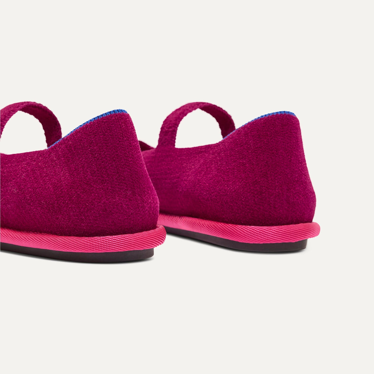 Close up of the heel of The Cruiser Mary Jane in ReVelvet Berry Pop, with Rothy's signature blue halo.