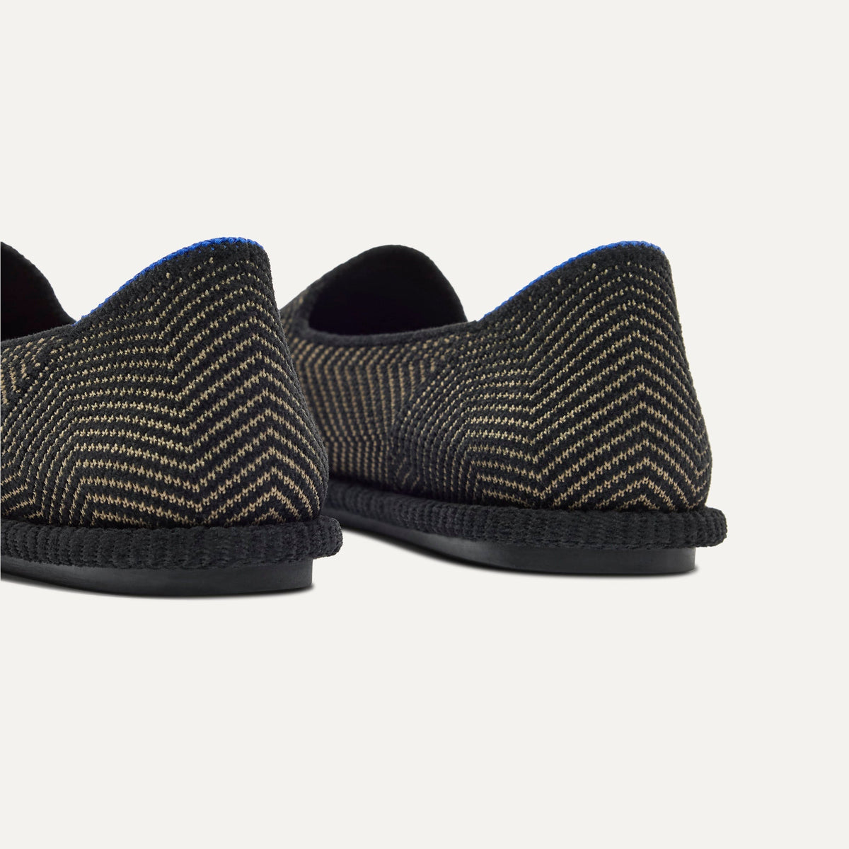 Close up of the heel of The Cruiser Loafer in ReVelvet Jet Herringbone, with Rothy's signature blue halo.
