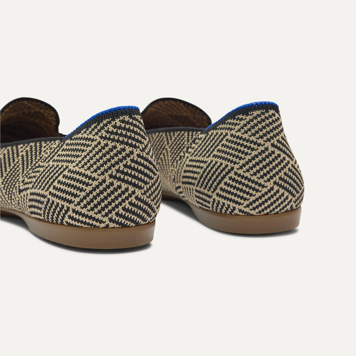 Close up of the heel of The Daily Loafer in Black Zig Zag, with Rothy's signature blue halo.
