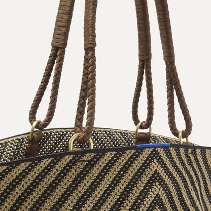 A close up of The Summer Tote in Toffee Chevron focusing on the pocket and handles.