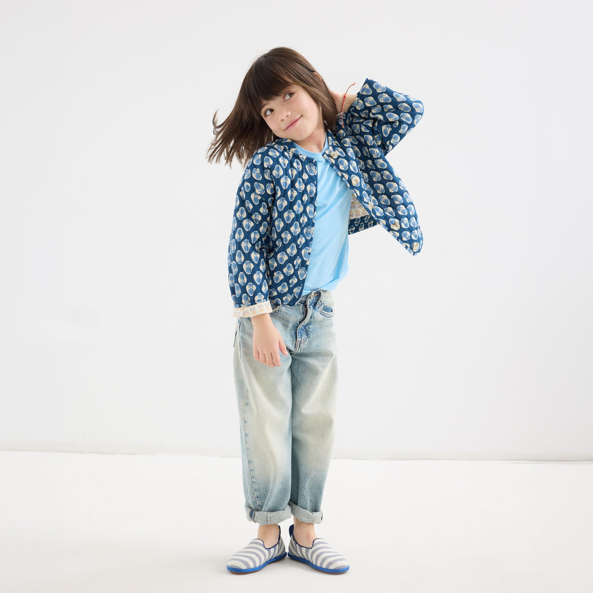 model | An alternate image of a model wearing The Mini Loafer in Harbor Stripe.