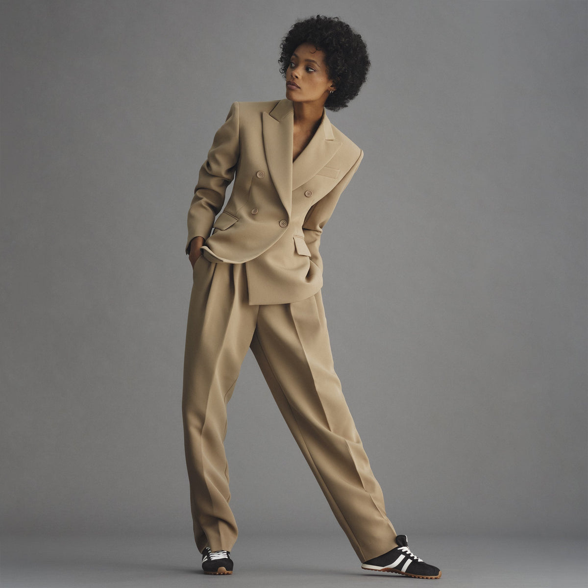model | Alternate view of a model wearing The Ivy Sneaker in ReVelvet Black.