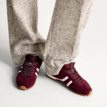 hover | Model wearing The Ivy Sneaker in ReVelvet Syrah.