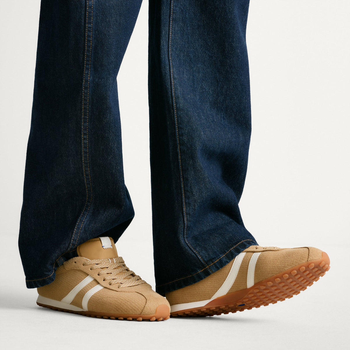 hover | Model wearing The Ivy Sneaker in ReVelvet Wren.