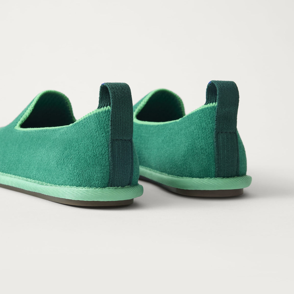 The Mini Loafer in ReVelvet™ Peapod shown from the back view with the heel detail.
