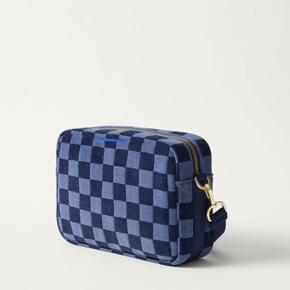 The Crossbody Camera Bag in ReVelvet™ Blue Ink, shown from the side.