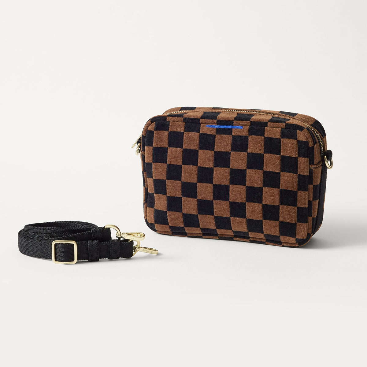 The Crossbody Camera Bag in ReVelvet™ Umber Check shown by itself with removable strap.